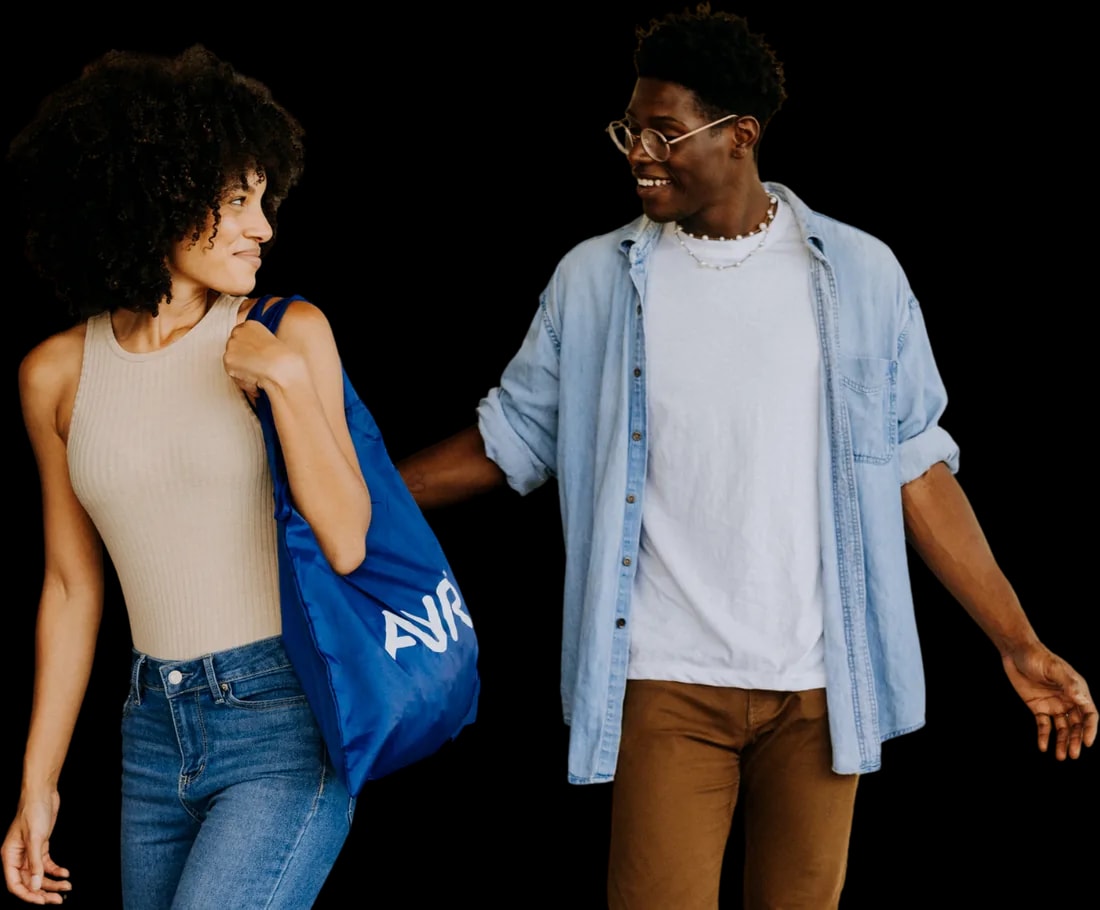 Two Ayr customers walking together carrying a blue Ayr shopping bag